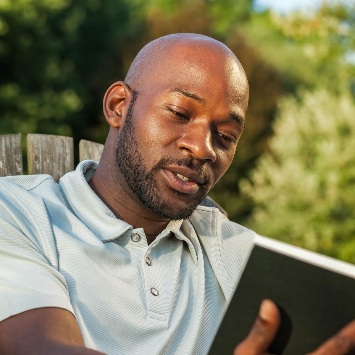 man reading a book outside