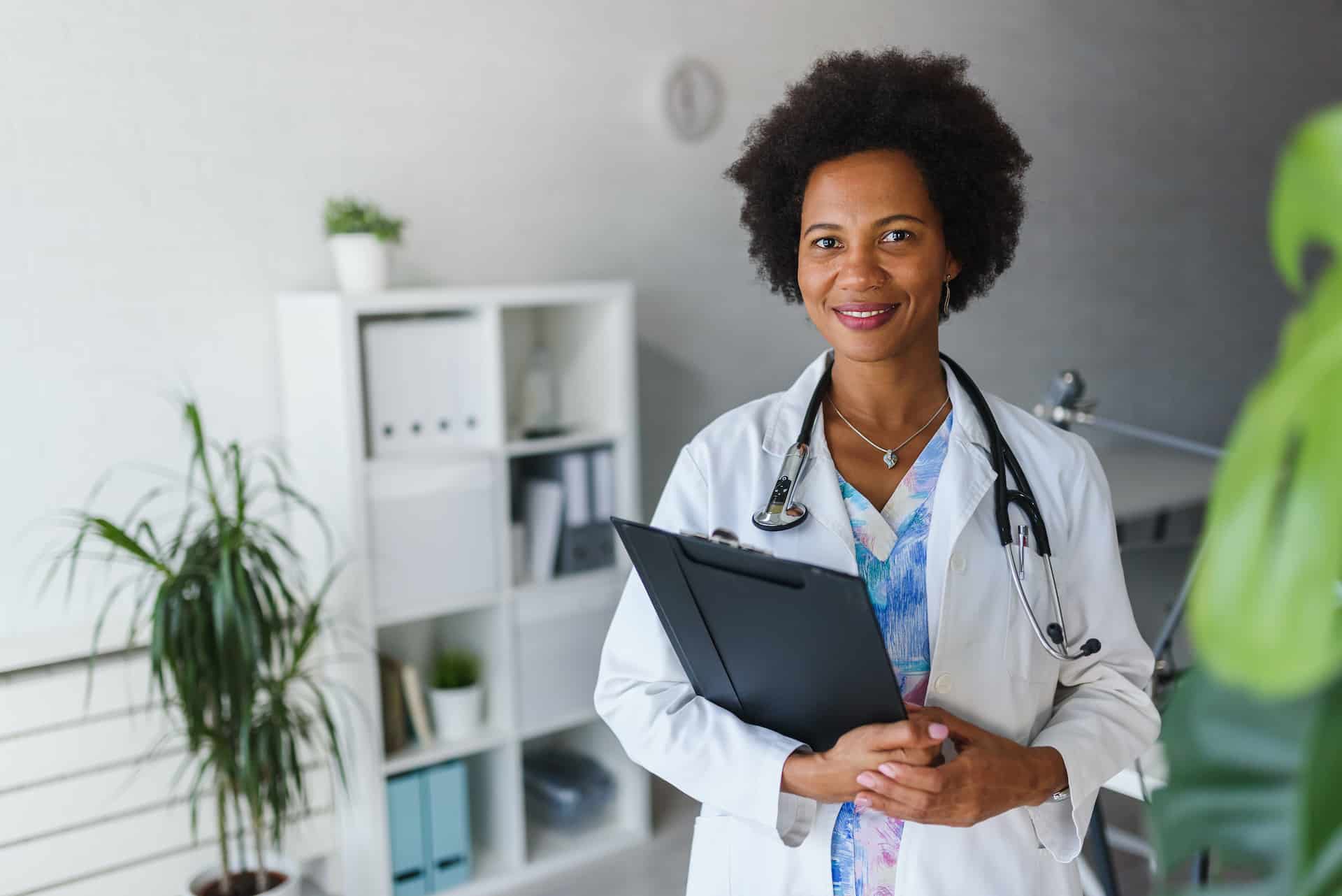 Portrait of female black doctor standing in her office at clinic